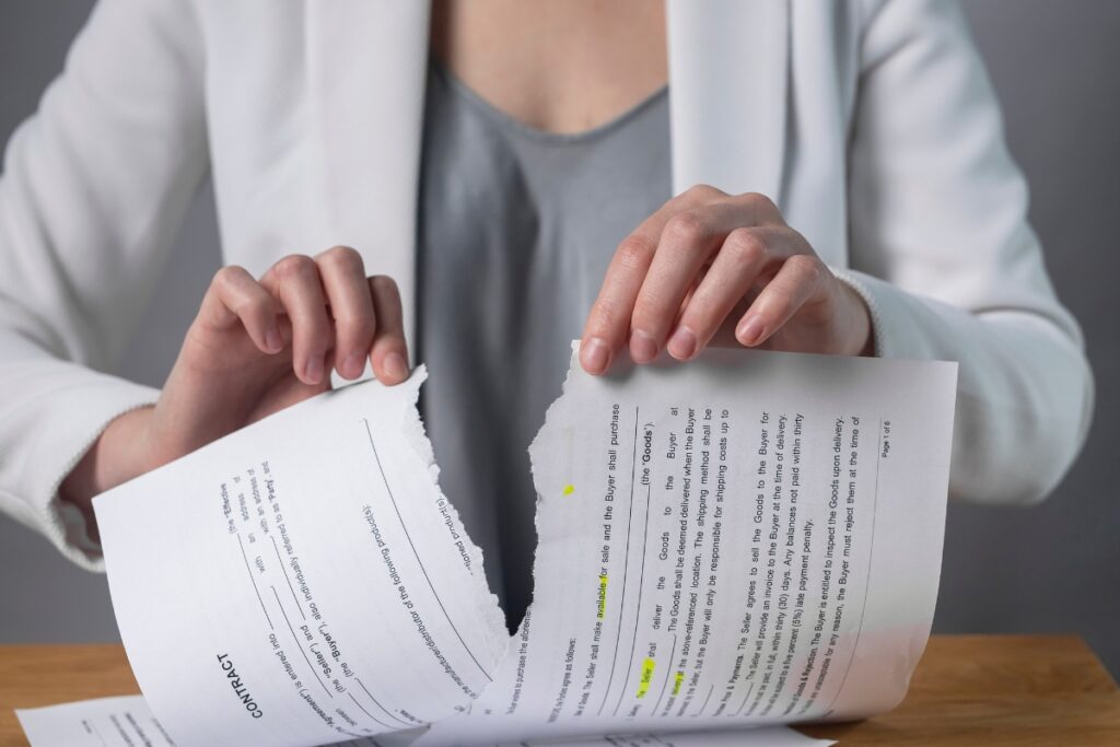 A woman is holding an incarceration record with a tear in it.