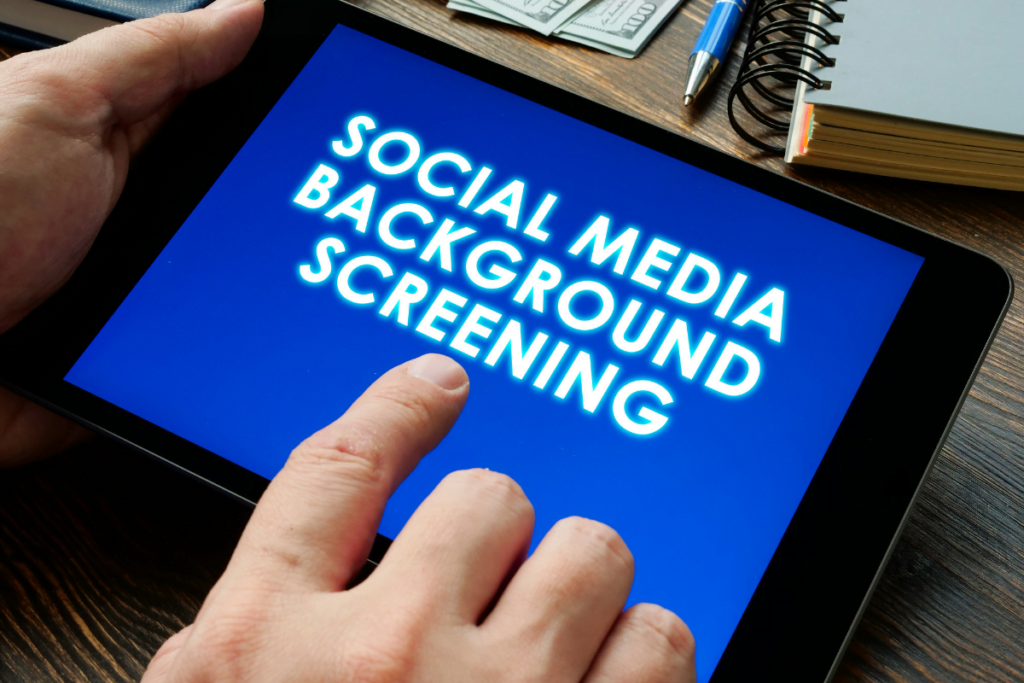 Legal Background Checks: Empowering Law Firms 1 A person holding a tablet with the word social media background screening.