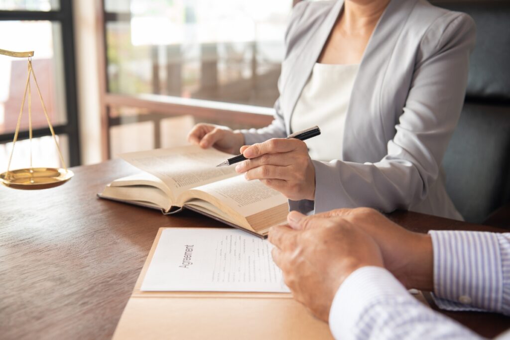 A lawyer diligently signing case briefs at a desk.