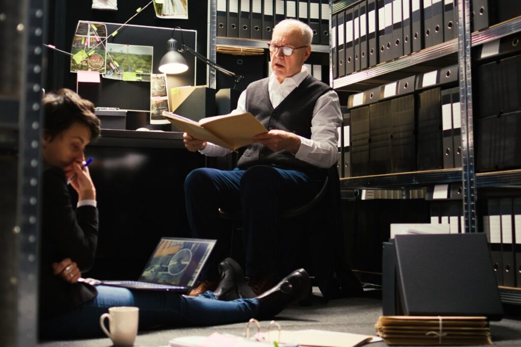 A man engrossed in reading a book in a library, taking into consideration any potential legal complaints.