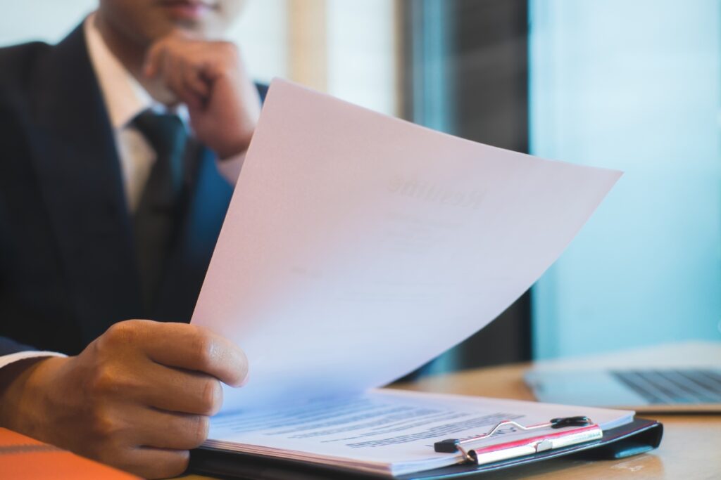 A man in a suit is holding a legal complaint.