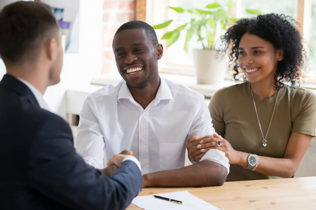 A man and woman are happily informed that they pass the tenant screening services for landlords.