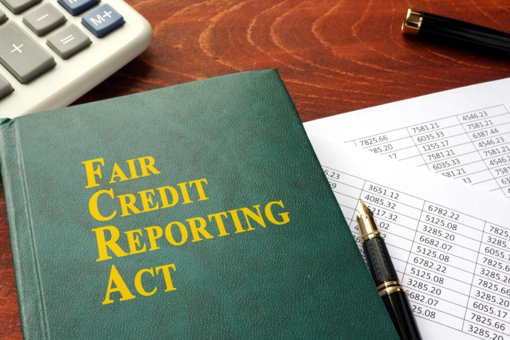 A book on FCRA compliance featuring the Fair Credit Reporting Act prominently.